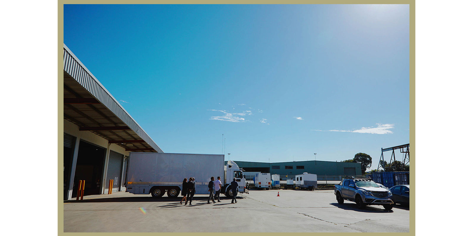 Wide shot of Melbourne Screen Hub, showcasing trucks and operations. 